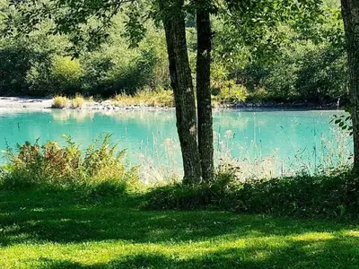 a body of blue water with trees and grass at 4 person holiday home in Oldedalen-By Traum in Briksdalsbre
