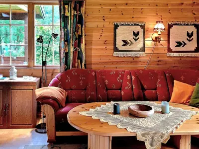 a living room with a red couch and a table at 4 person holiday home in Oldedalen-By Traum in Briksdalsbre