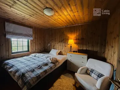 a bedroom with a bed and a desk and a chair at Large cabin at Nesfjellet with lovely view, inddor Jacuzzi & sauna in Nes i Ådal