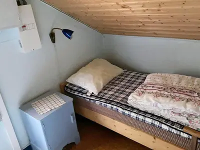 a small bed in a small room with a lamp at 4 person holiday home in HARDBAKKE-By Traum in Hardbakke