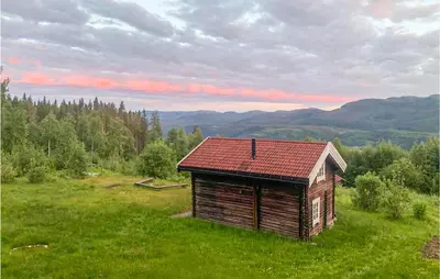 a small wooden building in a field with mountains in the background at 2 Bedroom Gorgeous Home In Eggedal in Eggedal