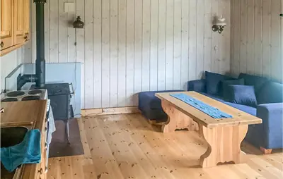 a living room with a table and a blue couch at 2 Bedroom Gorgeous Home In Eggedal in Eggedal
