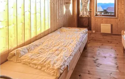 a large bed in a room with a window at 5 Bedroom Gorgeous Home In Eggedal in Eggedal