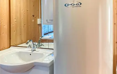 a bathroom with a sink and a toilet and a mirror at 5 Bedroom Gorgeous Home In Eggedal in Eggedal