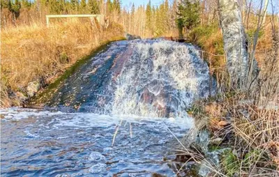 a waterfall in the middle of a field at 5 Bedroom Gorgeous Home In Eggedal in Eggedal