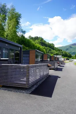 a row of mobile homes parked on the side of a road at Koie Smart in Stranda