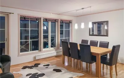 a dining room with a wooden table and chairs at Awesome Apartment In Tyinkrysset in Tyinkrysset