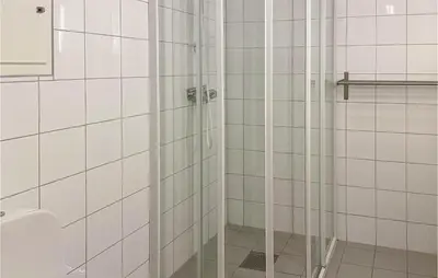 a bathroom with a shower with white tiled walls at Awesome Apartment In Tyinkrysset in Tyinkrysset