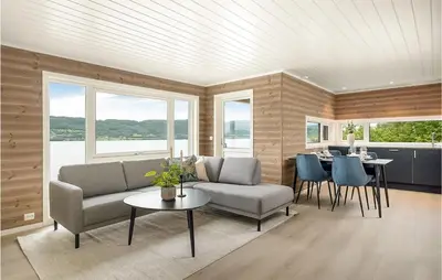a living room with a couch and chairs and a table at Stunning Home In Gjemnes With Wifi in Stokke