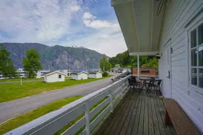 a porch with chairs and a table on a house at Koie Family in Stranda