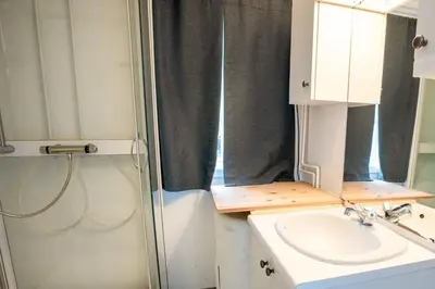 a bathroom with a shower and a sink and a mirror at Koie Family in Stranda