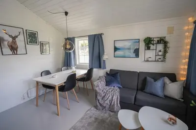a living room with a couch and a table at Koie Family in Stranda
