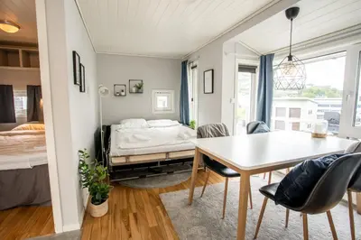 a room with a bed and a table and chairs at Koie Standard in Stranda