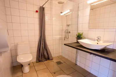 a bathroom with a sink and a toilet at Koie Standard in Stranda