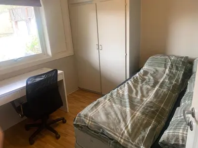 a bedroom with a bed and a desk and a computer at Hemsedal Ulsåk in Torset