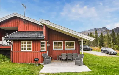 a red house with a table and chairs in front of it at Gorgeous Home In Hemsedal With Sauna in Hemsedal