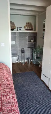 a room with a bathroom with a tub and a rug at Exceptional Cottage 2 meters from the sea, possible to rent boat, Bekkjarvik, 60 km from Bergen in Gauksheim