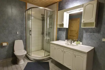 a bathroom with a shower and a sink and a toilet at Fully equipped cabin by the fjord in Volda