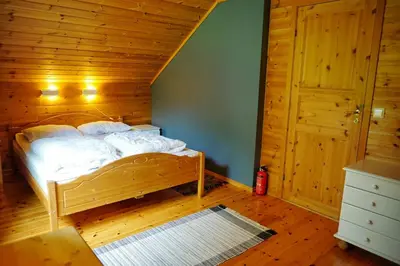 a bedroom with a bed in a wooden room at Fully equipped cabin by the fjord in Volda