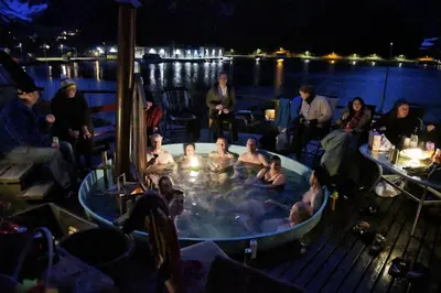 a group of people sitting in a hot tub at Fully equipped cabin by the fjord in Volda