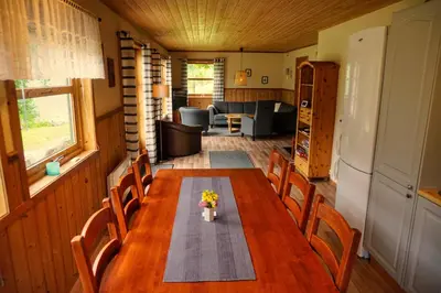 a dining room table and chairs in a house at Fully equipped cabin by the fjord in Volda