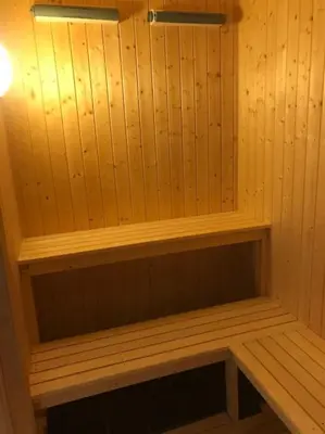 a sauna with wooden walls and a wooden shelf at Stor familiehytte på Småsætra, Sjusjøen in Sjusjøen