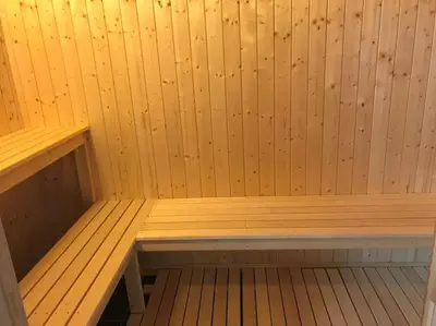 a small wooden sauna with a bench in it at Stor familiehytte på Småsætra, Sjusjøen in Sjusjøen
