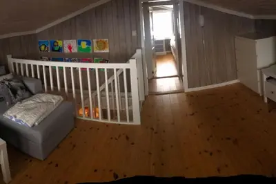 a living room with a couch and a crib at Stor familiehytte på Småsætra, Sjusjøen in Sjusjøen