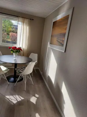 a dining room with a table and chairs and a window at peaceful place in Hønefoss
