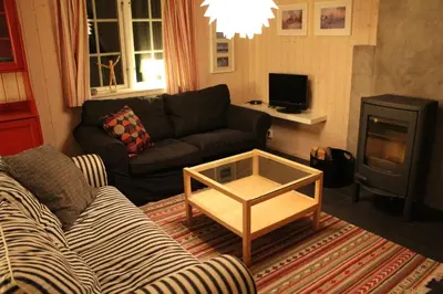 a living room with a couch and a coffee table at Gålå Fjellhytte - cabin with sauna and whirlpool tub in Sør-Fron