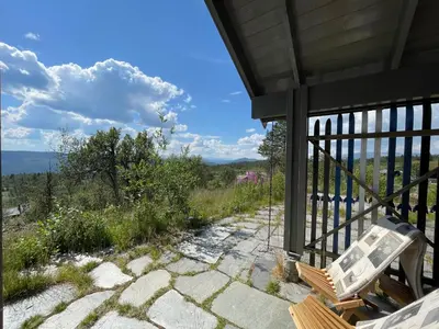 a porch of a house with a swing at Svarthamar - cabin with amazing view in Ål