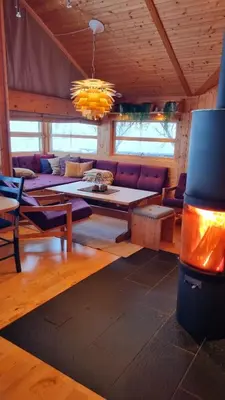 a living room with a couch and a table at Svarthamar - cabin with amazing view in Ål