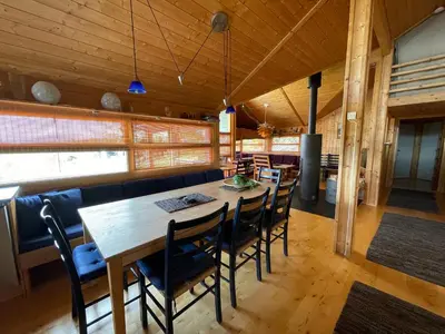 a dining room with a wooden table and chairs at Svarthamar - cabin with amazing view in Ål