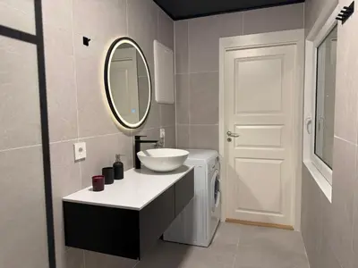 a bathroom with a sink and a mirror at Chausseen Apartments in Krogsti