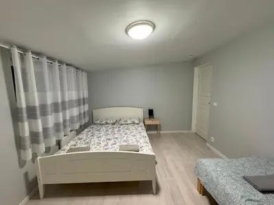 a white bedroom with a bed and a window at Chausseen Apartments in Krogsti