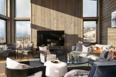 a living room with couches and a large television at Riddertunets top notch in Beitostøl