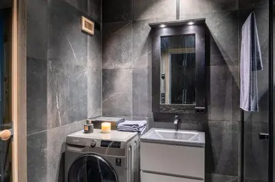 a bathroom with a washing machine and a sink at Riddertunets top notch in Beitostøl