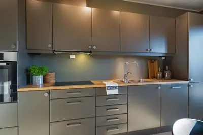 a kitchen with stainless steel cabinets and a sink at Riddertunet deluxe in Beitostøl