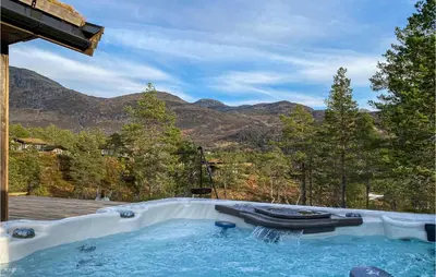 a hot tub with a view of the mountains at 4 Bedroom Amazing Home In Stryn in Stryn