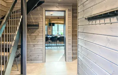 a pivot door in a house with a dining room at 4 Bedroom Amazing Home In Stryn in Stryn