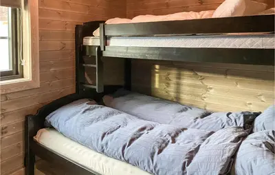 two bunk beds sitting in a room with a wall at 4 Bedroom Amazing Home In Stryn in Stryn