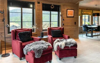 a living room with two red chairs and a table at 4 Bedroom Amazing Home In Stryn in Stryn