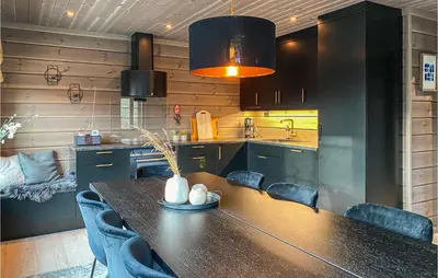 a kitchen with a table and some blue chairs at 4 Bedroom Amazing Home In Stryn in Stryn