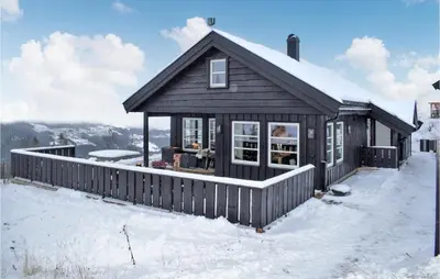 a black house with a fence in the snow at Pet Friendly Home In Gol With Sauna in Gol