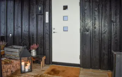 a room with a white door and a table with a candle at Pet Friendly Home In Gol With Sauna in Gol