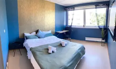 a bedroom with a large bed with towels on it at Gjøvik Overnatting in Gjøvik