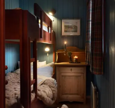 a bedroom with a bunk bed and a night stand at Vestlia Ski in Geilo