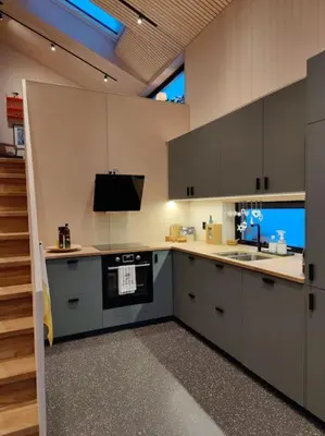 a kitchen with a sink and a stove top oven at Huset ved skogen in Isfjorden