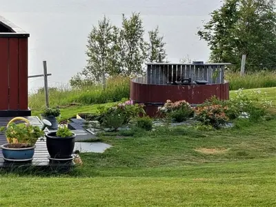a garden with plants in pots on a wooden deck at Rekdal in Vestnes