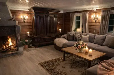 a living room with a couch and a fireplace at Traditional timber farm with Sauna & Wi-Fi in Baukål